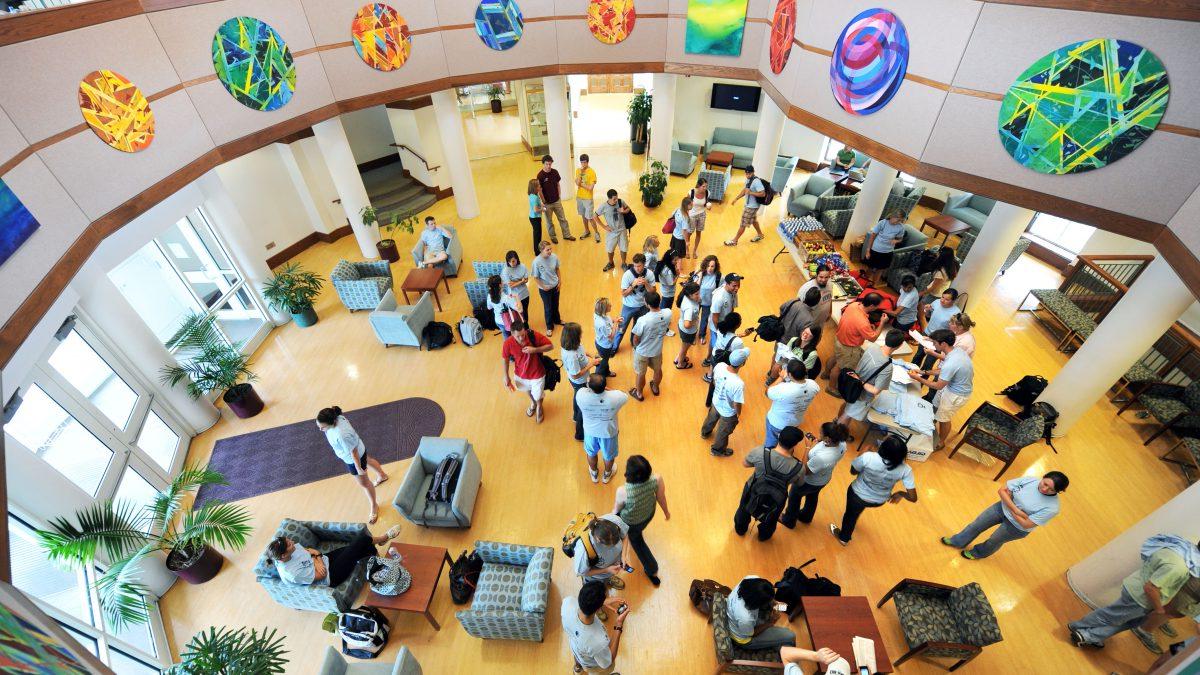 Students, faculty and staff gather in the law school rotunda.